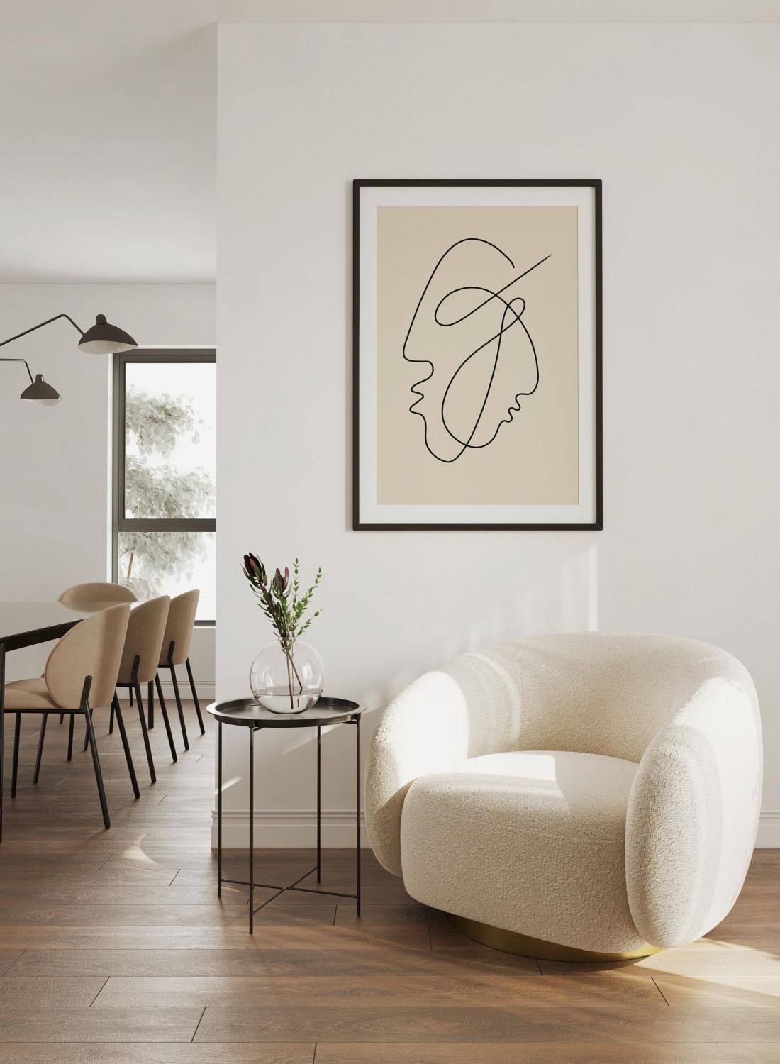 A cozy white armchair and side table by wall art in a modern, minimalist living space with wooden floors.
