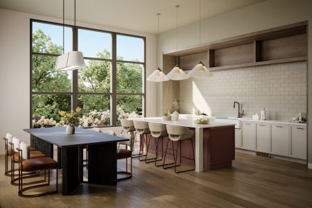 Modern kitchen with large windows, island seating, pendant lights, and a dining table with chairs. Trees are visible outside.